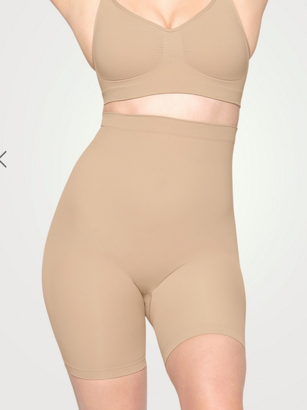 SKIMS Sculpting High-Waist Mid-Thigh Shorts in Tan